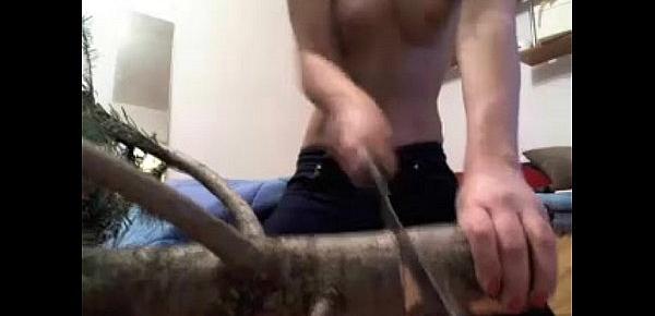  Topless girl tries to cut a Christmas tree with a knife